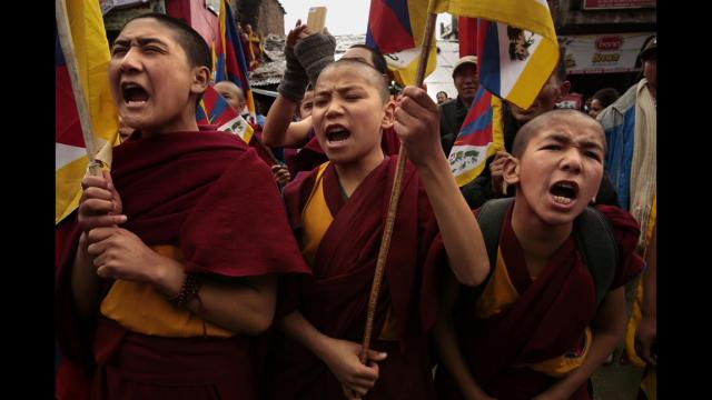 WHAT IS TIBET'S FUTURE?  TIBETAN UPRISING DAY, MARCH 10, 2014. YOUNG TIBETAN MONKS PROTESTING TIBET'S MILITARY OCCUPATION.