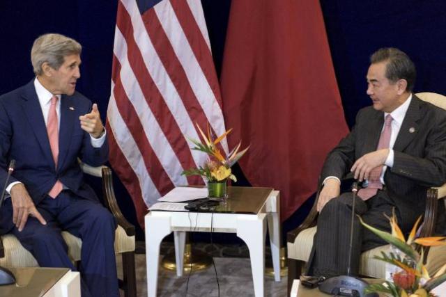 US Secretary of State John Kerry (L) and China's Foreign Minister Wang Yi talk before a bilateral meeting at the Putra World Trade Center August 5, 2015 in Kuala Lumpur, Malaysia.  REUTERS/Brendan Smialowski/Pool