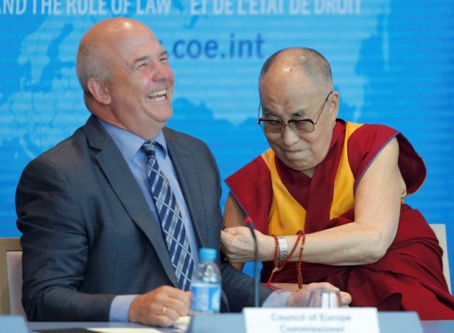 Tibet's exiled spiritual leader the Dalai Lama (R) jokes with Nils Muiznieks, Commissioner for Human Rights of the Council of Europe, during his visit at the Council of Europe in Strasbourg, France, September 15, 2016.  REUTERS/Vincent Kessler